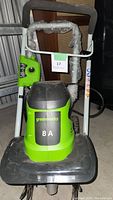Front view of Greenworks cultivator showing brand and 8 amp label.