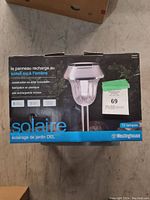 Box front with product image and branding, features in French, showing 10 lamp count, stainless steel construction and rechargeable battery included.