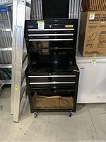 Full front view of the Stanley tool cart with ladder to left