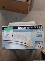 Photo of the Braun Vario 6000 Standard steam iron original packaging showing front of box with product image and branding.