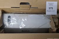 Top view of the lamination slot and control panel of the Scotch thermal laminator still sealed in plastic inside the box