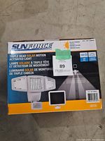 Front of the box showing product name, brand Sunforce, and an image of the triple head solar motion light. Highlights 180° detection and solar powered feature.
