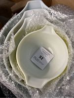 Top view of nested Pyrex mixing bowls wrapped in bubble wrap showing white color of largest bowls