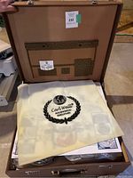 Brown case opened showing yellow dust bag with Carl Weill logo