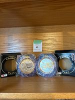 Shows two purple Chokin vases with their original boxes on either side, placed on wooden surface.