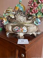 Front view of ornate Capodimonte porcelain urn with applied flowers