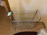 Front view of the metal shoe rack showing two wire shelf levels and plastic feet.