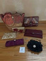 Lot displayed on wooden floor showing all purses and clutches from above.