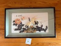 Front view of the framed vintage Chinese shell art showing two cranes, flowers, and leaves with Chinese calligraphy in the upper left corner, all framed in a wooden frame with a pale green inner border.