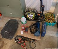 Photo showing RAV4 floor mats, power washer, jumper cables, vacuums, rope, and other items