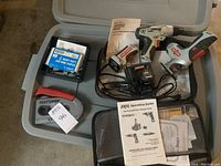 Overall lot items including Craftsman multi saw, drill, driver, flashlight, stapler with heavy duty staples, manuals, battery pack, and charger in plastic case.