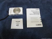 Front view of white camera body with lens