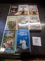 Set of 7 Anne of Green Gables paperback novels, volumes 1 to 8, arranged in a grid on a dark surface
