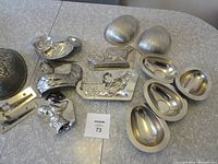 Photo showing full set of assorted vintage Easter chocolate molds including eggs, rabbits, hen, and a decorative mold