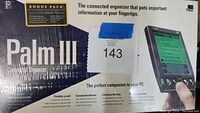 Photo of front of the box highlighting the Palm III connected organizer with Bonus Pack, emphasizing portability, infrared connection, and extensive memory.