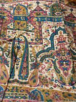 Close-up showing intricate multicolor silk fabric patterns with gold accents.