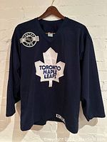 Front view of navy blue Toronto Maple Leafs hockey jersey with Central Ice patch and CCM tag.