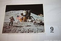 Full view of the signed Apollo 15 photo showing astronaut Jim Irwin on the moon, saluting the American flag with lunar module and rover in background.