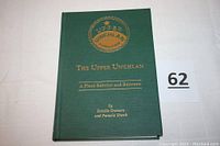 Front green hardcover book with gold embossed title and insignia 'Upper Uwchlan'