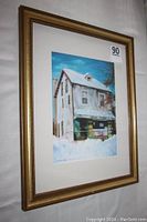 Photo of the framed print propped up showing the full artwork and frame, with sticker '90' visible