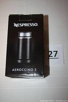 Original box of Nespresso Aeroccino 3 milk frother in black, showing branding and product image on front.