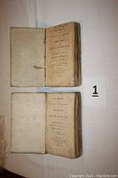 Two open volumes showing title pages and lot label