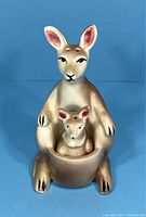 Front view of ceramic kangaroo with baby in pouch, showing facial details and coloring