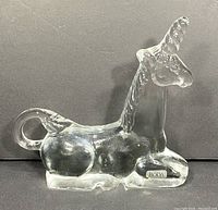 Front and side view of the clear glass unicorn figurine with BODA label visible on the side, showing shape and size.