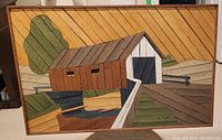Front view of the signed wooden lath folk art showing a covered bridge over a small river with trees, signature visible.