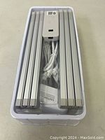 LED light strips, control unit and cords in plastic packaging, showing branding and buttons