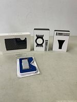 Full view showing Ridge wallet box, two Ridge accessories boxes, HTS Accessories money clip in packaging, and Clutch Slide accessory in packaging.