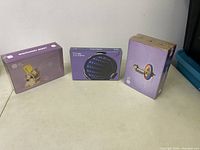 Three MEL Science kits displayed: a gyroscope toy kit, a reflections experiment kit, and a refractions light cell kit, all in purple packaging.