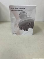 Front view of box shows product image and name 'Smart scalp massager', model ST-701.