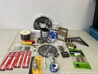 Wide view showing all new tools and accessories including saw blades, hardware, tubing, brake pads.