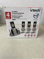 Front view of the VTech cordless answering system box showing the base unit and 4 handsets, highlighting caller ID and call waiting feature.