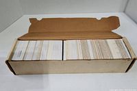 Box of hockey cards stored in cardboard box with dividers and handwritten numbering on the side