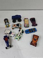 Overhead view of all 10 toy cars showing colors and types.