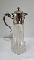 Full view of the antique glass pitcher with silverplated hinged lid and handle.