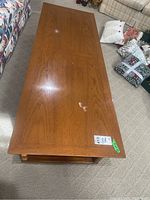 Top view of the wood coffee table showing its rectangular shape and surface wear.