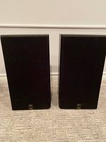 Pair of Celestion DL8 stereo speakers with black fabric grilles and Celestion DL8 badges on front bottoms.