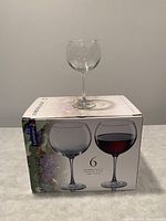 Photo showing a single wine glass on top of the original Luminarc box, which states it contains 6 wine glasses.