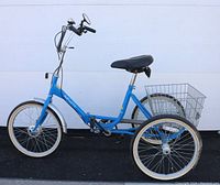Full side view of blue adult folding tricycle with rear wire basket, black seat, chrome fenders and handlebars
