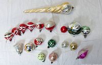 Overview of all 19 ornaments laid out, showing variety in size, color and design