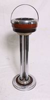 Full height view of the standing ashtray showing the triple chrome column support and round base with brown accent matching the ashtray top.