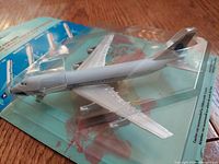 Close-up of Swiss Air DC-10 diecast model in packaging, showing detailed fuselage and tail design