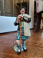 Full view of the Royal Doulton 'The Laird' 2361 figurine showing front and side detail on hardwood floor.
