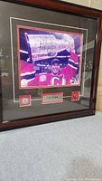 Full view of framed signed photograph showing Martin Brodeur holding the Stanley Cup, with signature visible.