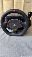 Front view of Logitech Momo Racing Wheel with central buttons and logos.