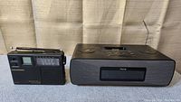 Front view of Grundig Traveller II portable radio and iHome clock radio side by side