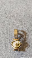 Full view of Mickey Mouse watch showing oval face, gold-tone metal case, and part of the bracelet.